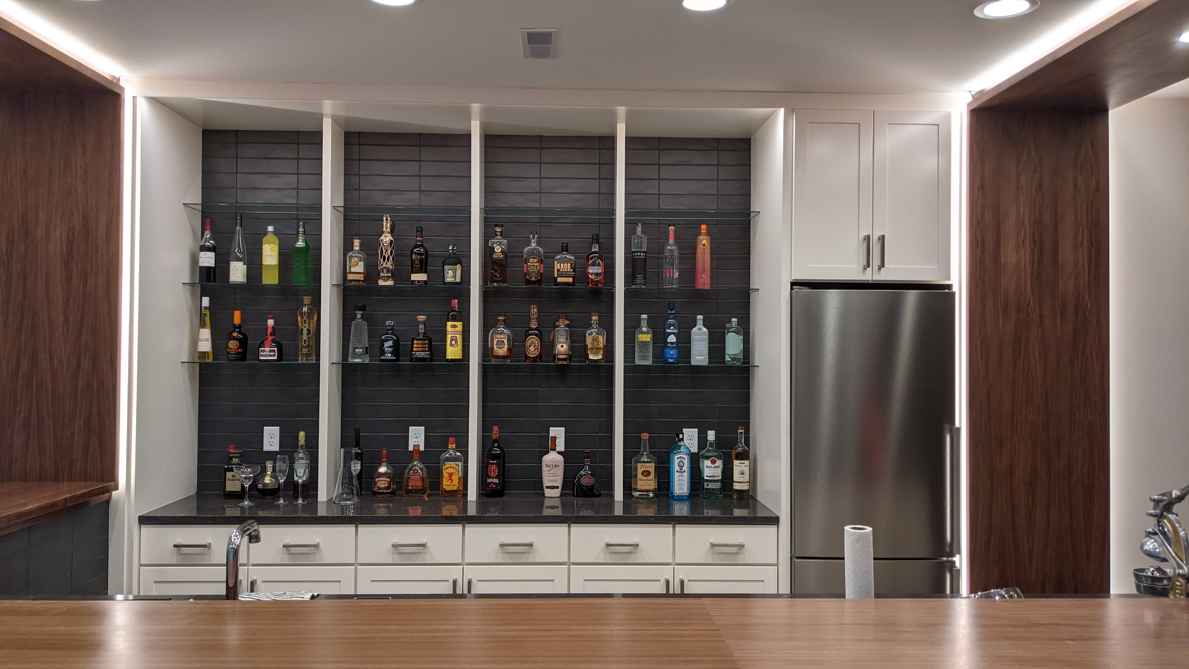 Custom Tiled Barback Istallation With Glass Shelves In Iowa